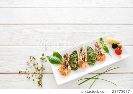 Delicious seafood on white background, copyspace Delicious seafood on white background, copyspace 23775957