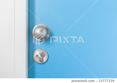 Metal silver doorknob on wooden door Metal silver doorknob on wooden door 23777159