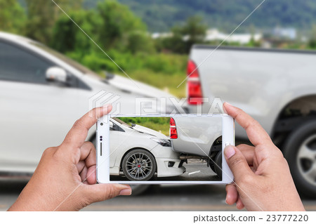 Hand of woman holding smartphone and take photo of car accident 23777220