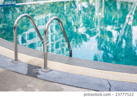 Swimming pool with shiny stainless steel stair 23777522
