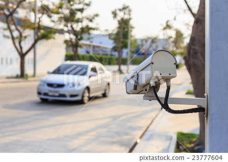 Security CCTV camera operating over the road 23777604