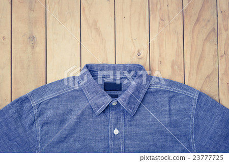Blue jeans on wooden background top view Blue jeans on wooden background top view 23777725
