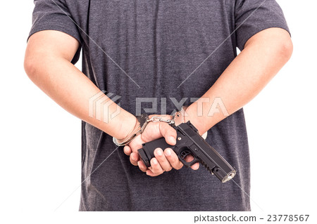 Close up man with handcuffs and gun on hands isolated on white Close up man with handcuffs and gun on hands isolated on white 23778567