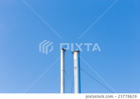 Two smokestacks on blue sky background in Thailand 23778629