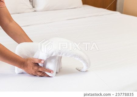 Hand set up white bed sheet in hotel room Hand set up white bed sheet in hotel room 23778835