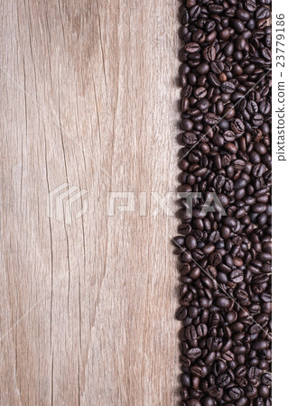 Coffee beans on wooden background, Composition with free space of wood 23779186