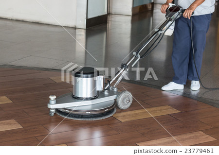 Woman cleaning the floor with polishing machine Woman cleaning the floor with polishing machine 23779461