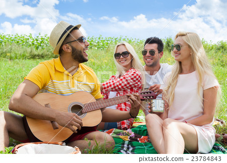 Young people listening guy playing guitar group Young people listening guy playing guitar group 23784843