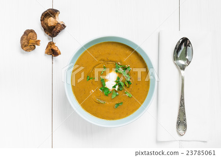 Mushroom soup garnished with fresh parsley 23785061