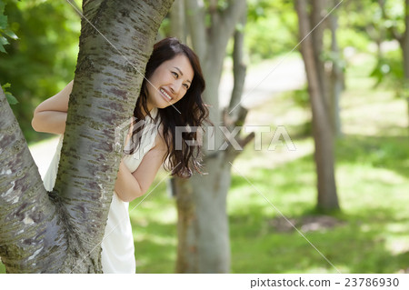 A lively middle woman who plays in early summer forest A lively middle woman who plays in early summer forest 23786930