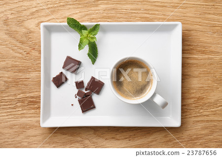 Espresso coffee with chocolate pieces on plate Espresso coffee with chocolate pieces on plate 23787656