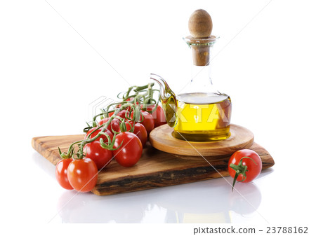 Bottle of olive oil and tomatoes ready for salad Bottle of olive oil and tomatoes ready for salad 23788162