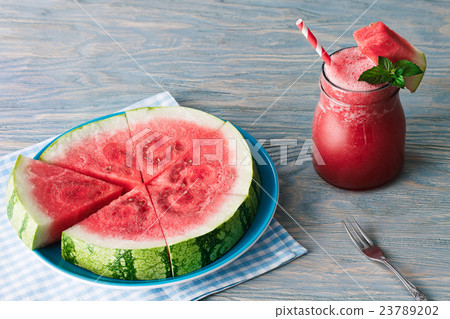 Water melon smoothie on blue wooden background Water melon smoothie on blue wooden background 23789202