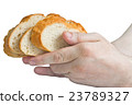 Man holding white bread slices in his hands 23789327