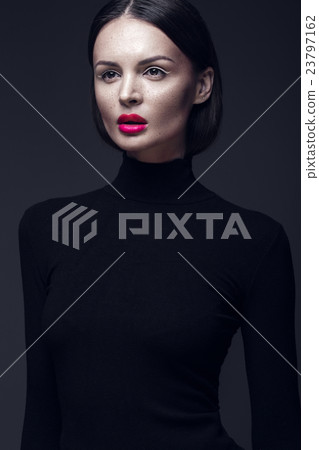 Beautiful brunette girl in a black dress, straight 23797162