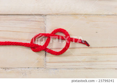 Figure-eight knot made with red rope Figure-eight knot made with red rope 23799241