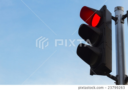 red color on the traffic light with  blue sky i 23799263