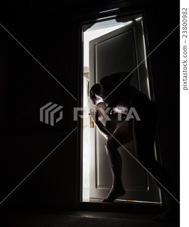 Man peeping through the door slot Man peeping through the door slot 23800982
