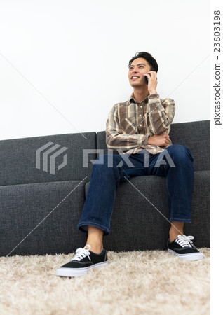A young man calling on a smartphone 23803198
