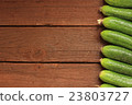 Cucumbers on wooden background 23803727