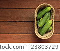 Cucumbers in a basket on wooden background 23803729