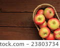 Apples in a basket on wooden background 23803734