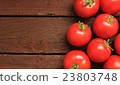 Tomatoes on wooden background 23803748