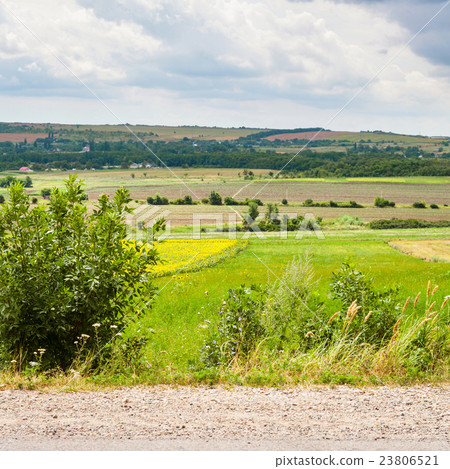 country landscape with road, fields and village 23806521