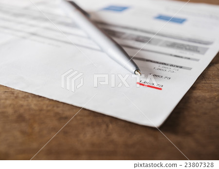 Bill and calculator on wooden table Bill and calculator on wooden table 23807328