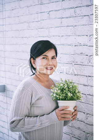 Woman with flower pot Woman with flower pot 23807597