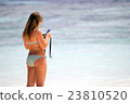 beautiful lady take play smartphone on the beach 23810520