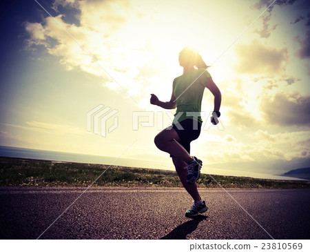 young fitness woman runner running on sunrise road young fitness woman runner running on sunrise road 23810569