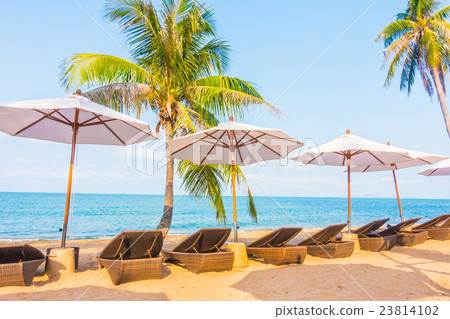 Umbrella and chair on the tropical beautiful beach Umbrella and chair on the tropical beautiful beach 23814102