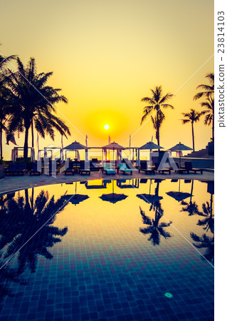 Beautiful Silhouette palm tree with umbrella and chair Beautiful Silhouette palm tree with umbrella and chair 23814103