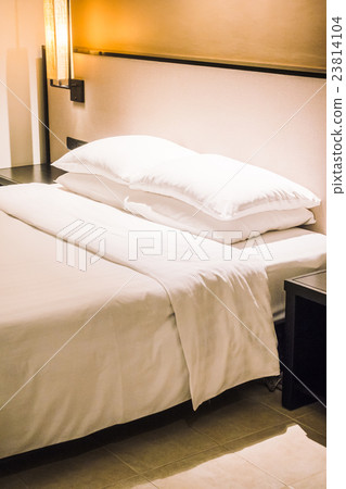 White pillow on bed 23814104