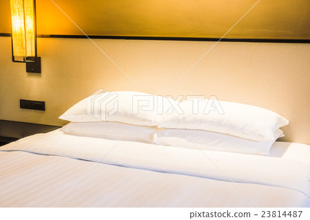 White pillow on bed 23814487