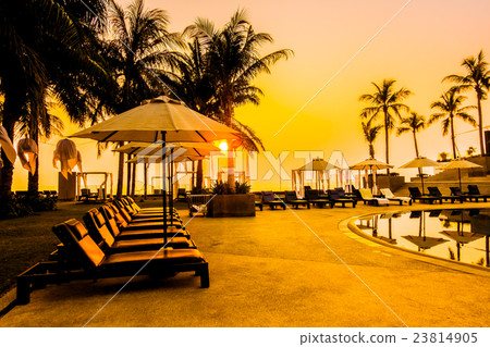 Beautiful Silhouette palm tree with umbrella and chair Beautiful Silhouette palm tree with umbrella and chair 23814905