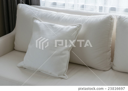 white decorative pillows on a casual sofa 23816697