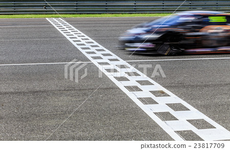 Race car crossing finish line, Motion blurred 23817709