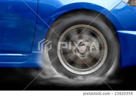 Blue car racing spinning wheel burns on floor. Blue car racing spinning wheel burns on floor. 23820354