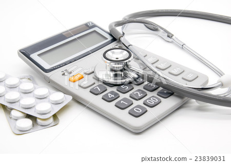 Calculator and stethoscopes on white background Calculator and stethoscopes on white background 23839031
