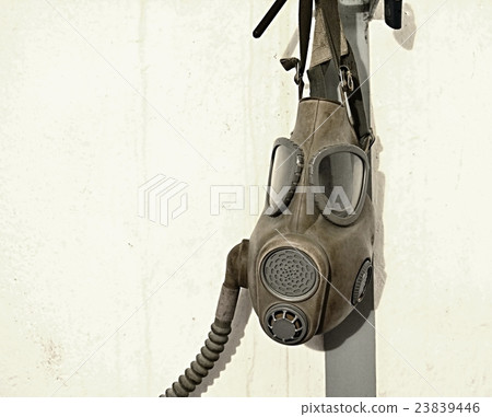 Old gas mask hanging on the wall. Old gas mask hanging on the wall. 23839446