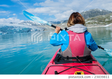 Woman kayaking on Styggvatnet glacier lake near Woman kayaking on Styggvatnet glacier lake near 23839811