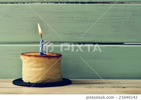 lit birthday candle on a cheesecake lit birthday candle on a cheesecake 23840142