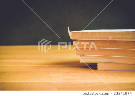 Parts of book on wooden table retro tone  23841974