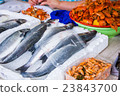 fresh fish in different sizes laying on a table 23843700