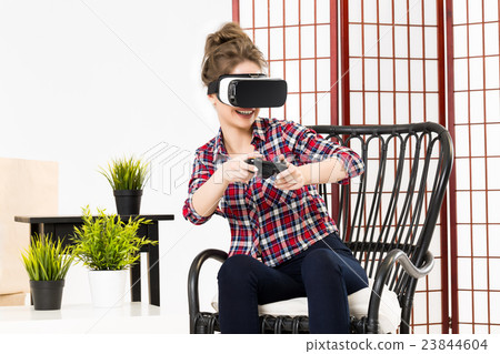 Girl getting experience using VR glasses of 23844604
