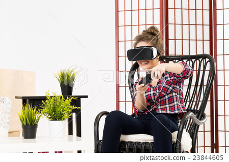 Girl getting experience using VR glasses of 23844605