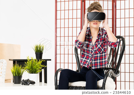 Girl getting experience using VR glasses of Girl getting experience using VR glasses of 23844610