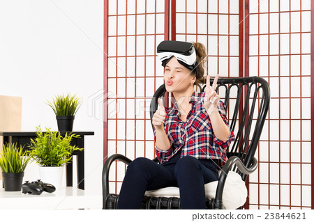 Girl getting experience using VR glasses of Girl getting experience using VR glasses of 23844621